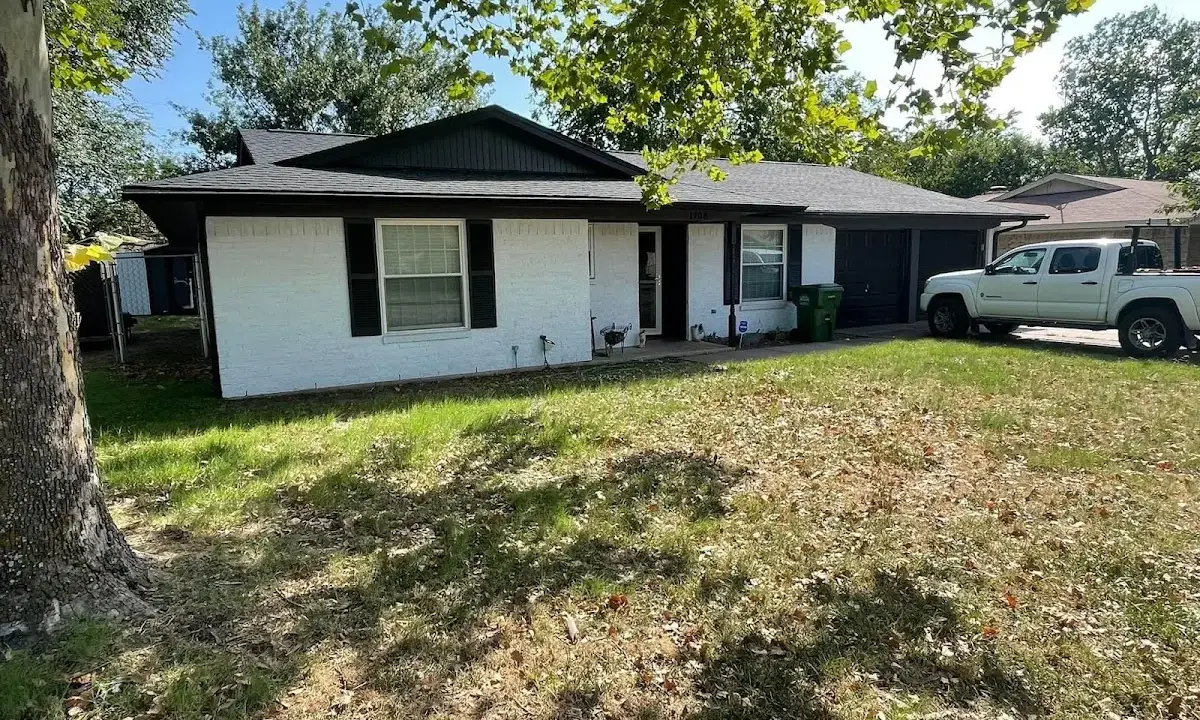 Professional roofing crew working on a residential roof in Otsego